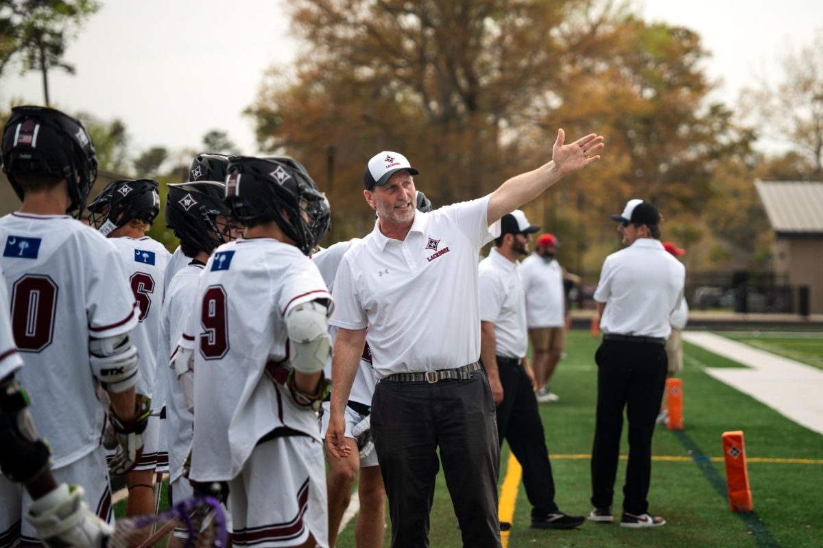 Defensive Coordinator Thomas Gribben speaks with his players after a close call on the field. 