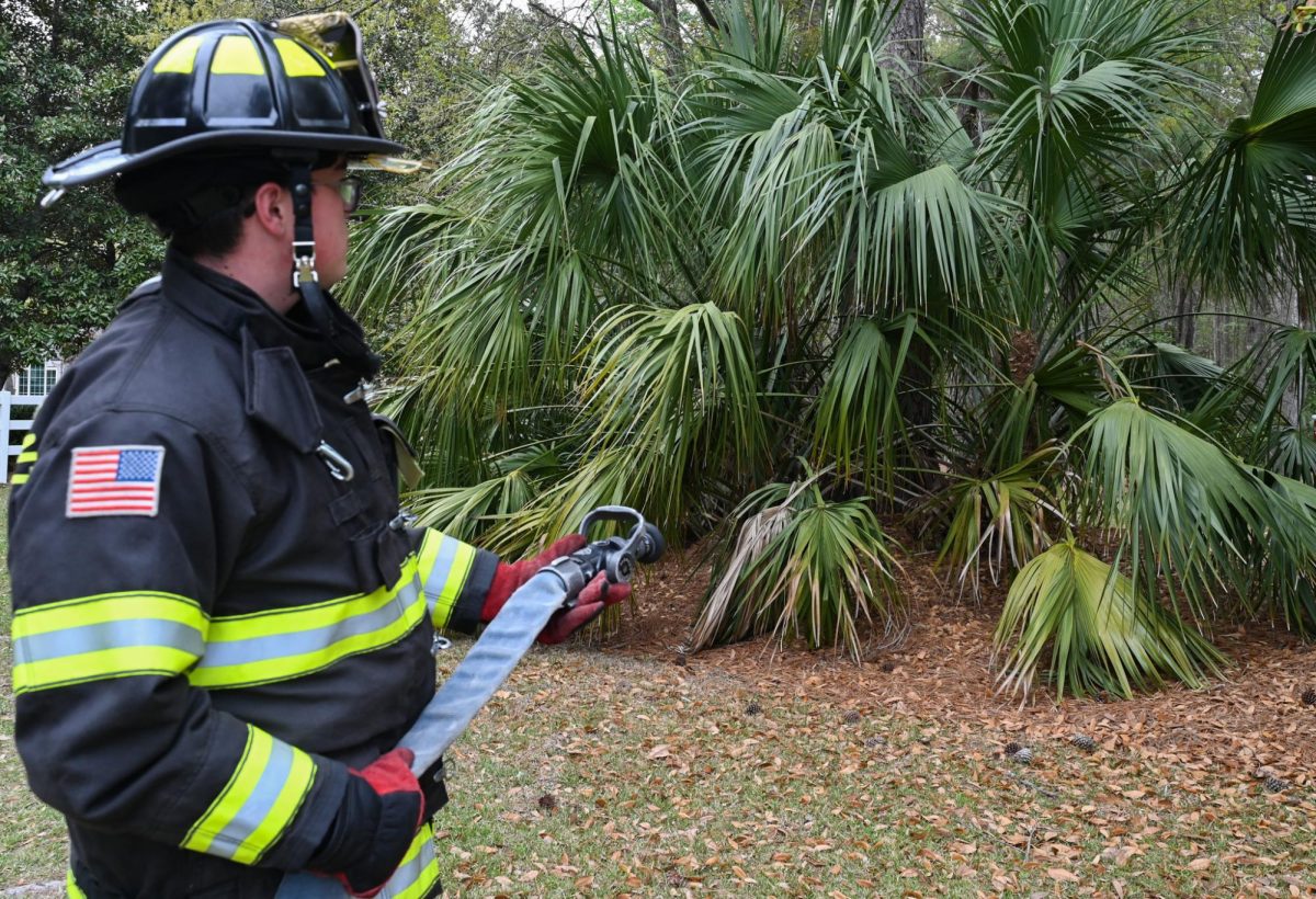 Firefighter from the Mount Pleasant departments displays the way fighters use fire hoses in the event of a fire.