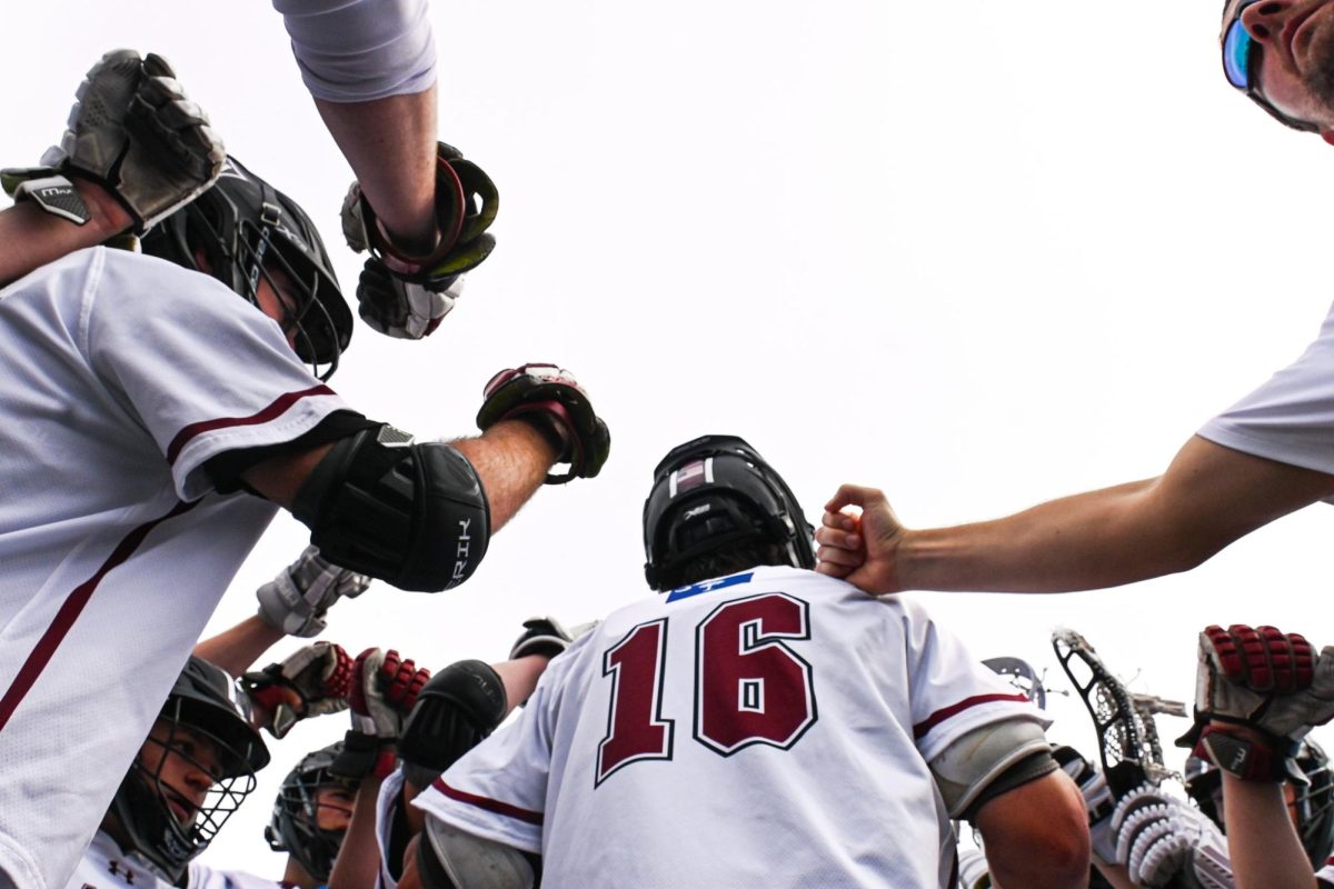 Wando Varsity Boys Lacrosse defense group huddles to establish their next play.