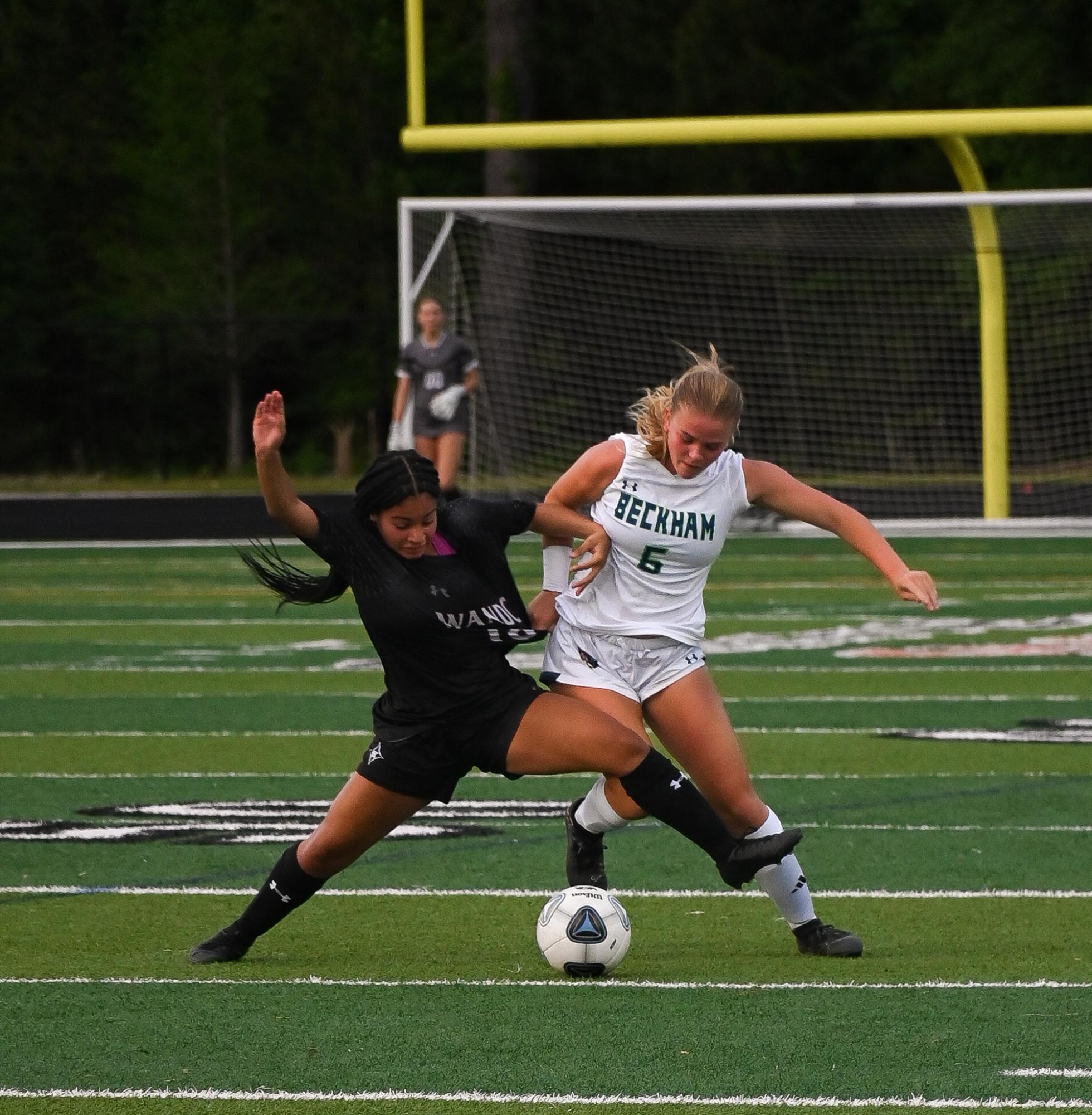 Sophomore Foward Zoey Carter defends the ball from a Lucy Beckham player.