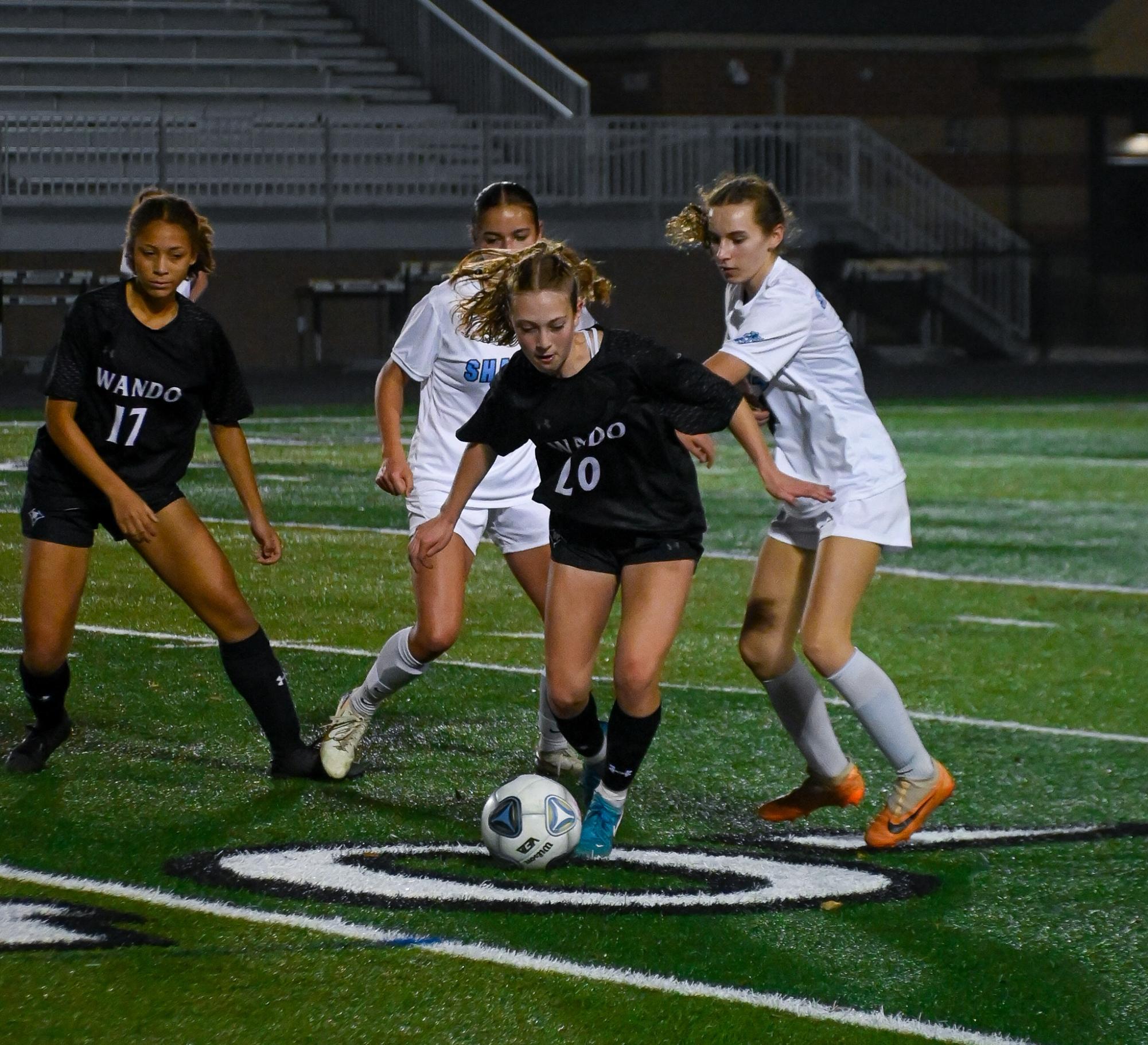 Freshman Midfielder Tenley Scanga defends the ball from opposing players.