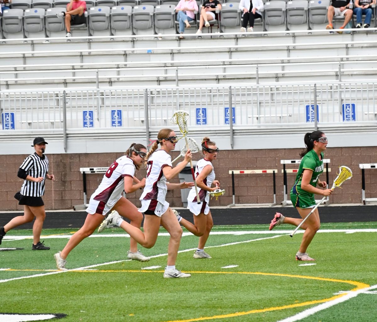 Sophomore Attacker Hayden Weeks and Freshman Midfielder Liv Polesovsky  chasing a Notre Dame player who has the ball.