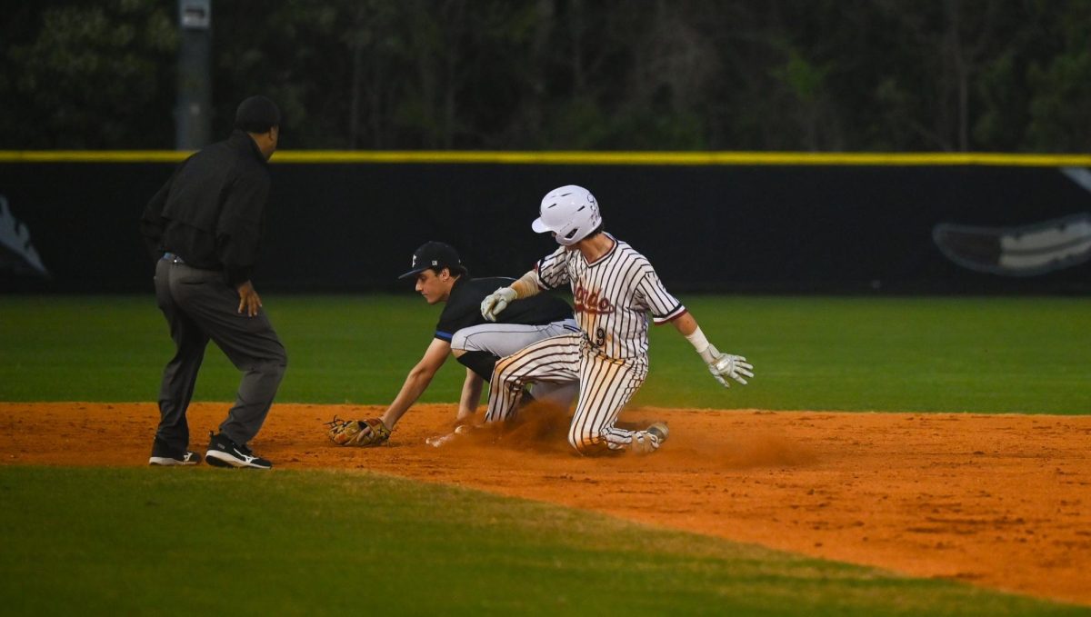 Junior catcher Jake DiMartino slides into second base. 