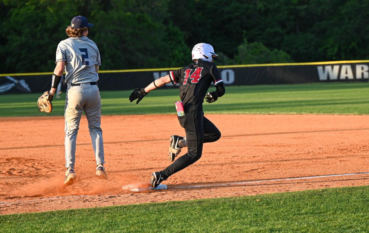 Senior infielder Brady Gold runs off first base. 