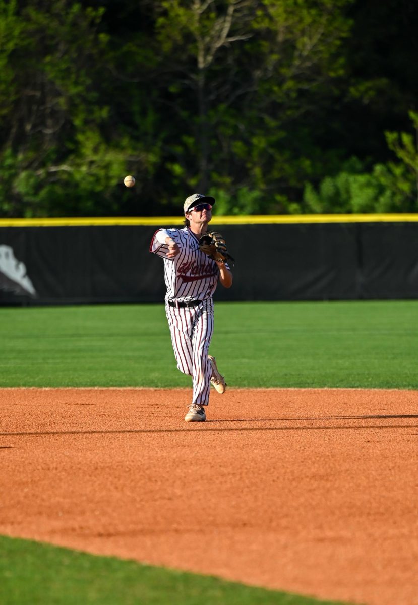 Senior infielder Lander Williams throws the ball to his teammate. 