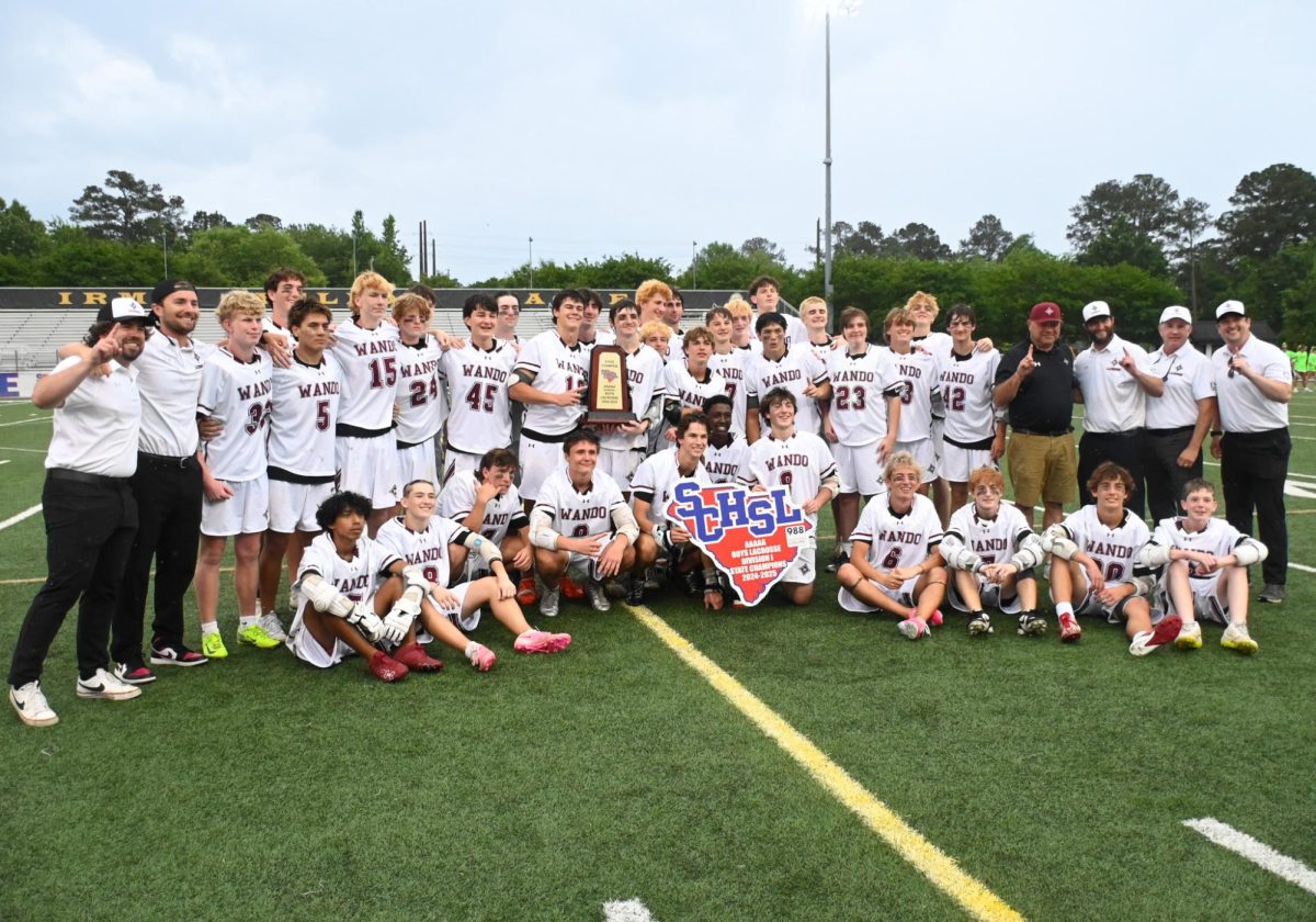 The whole Varsity LAX team posing with their trophy 