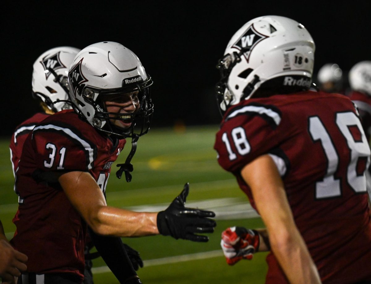 Freshman Defensive Back Noah Burton daps up his teammate.