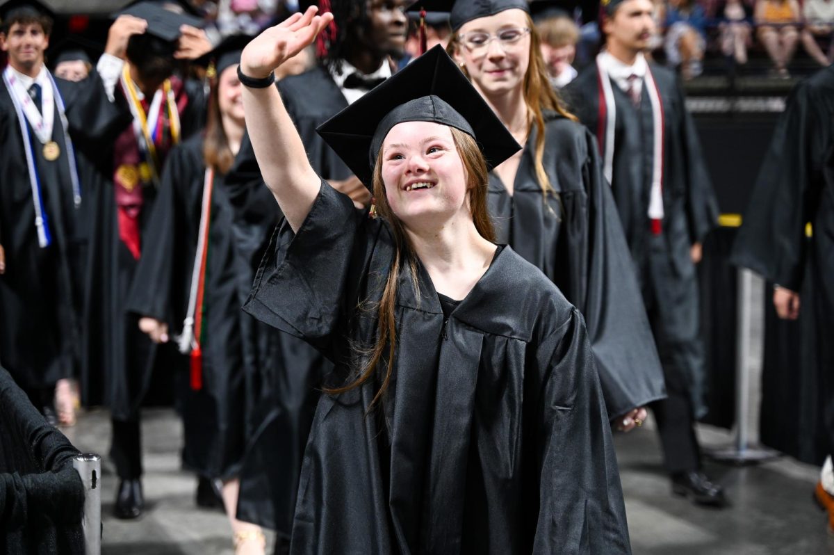 Senior Claire Vail smiles and waves at family. 