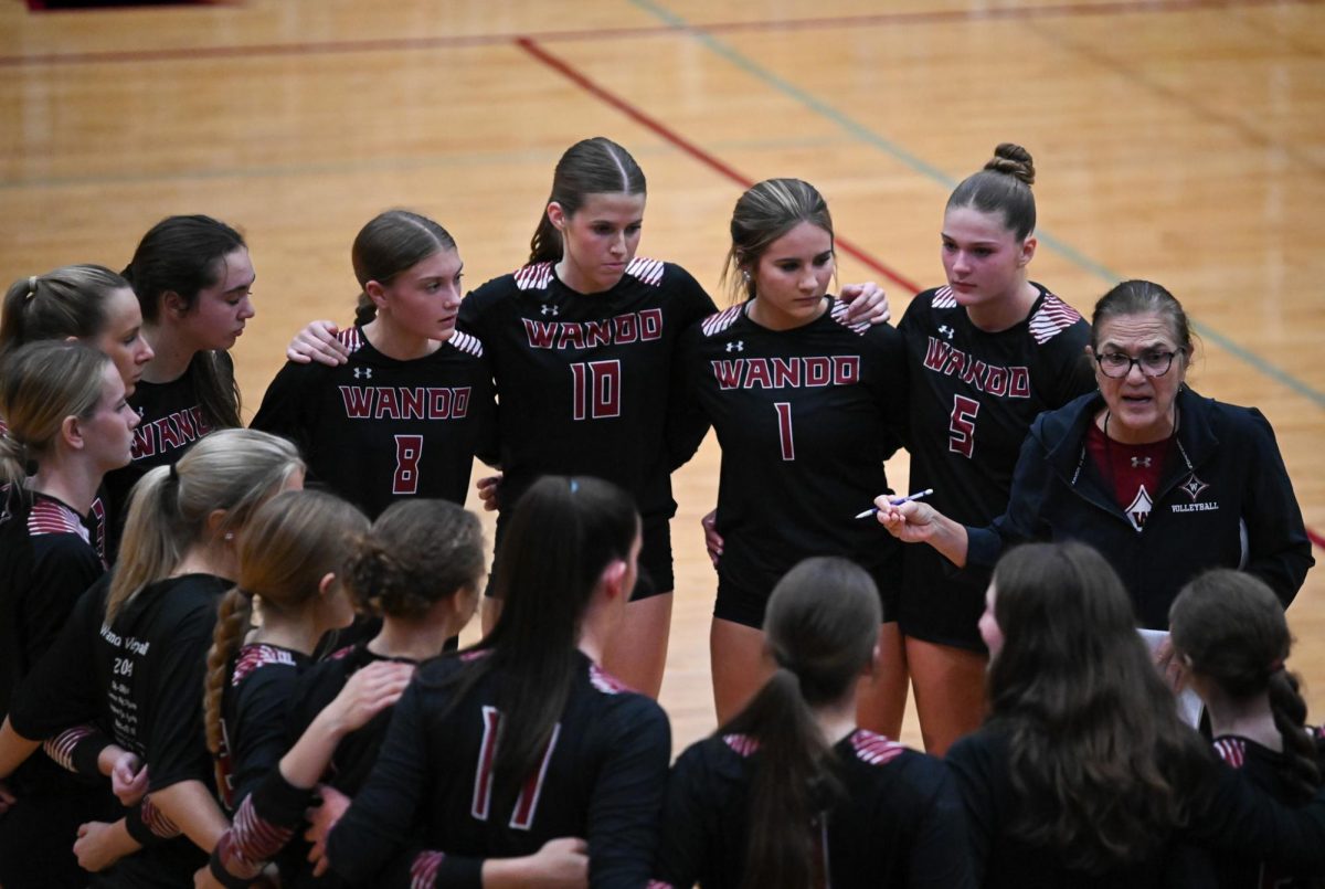 Wando Girls Volleyball gathers around Coach Glover during a time out.