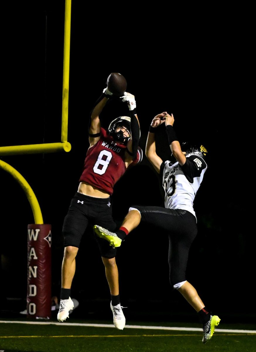 Playing deep coverage, McCarty leaps up in an attempt to intercept a pass from the Goose Creek quarterback. 