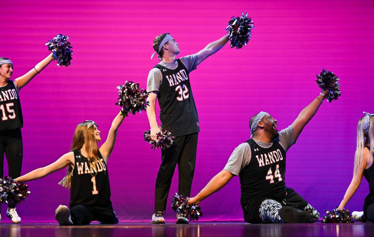 In an image from November's dance showcase, a conglomeration of students preform in Wando jerseys.