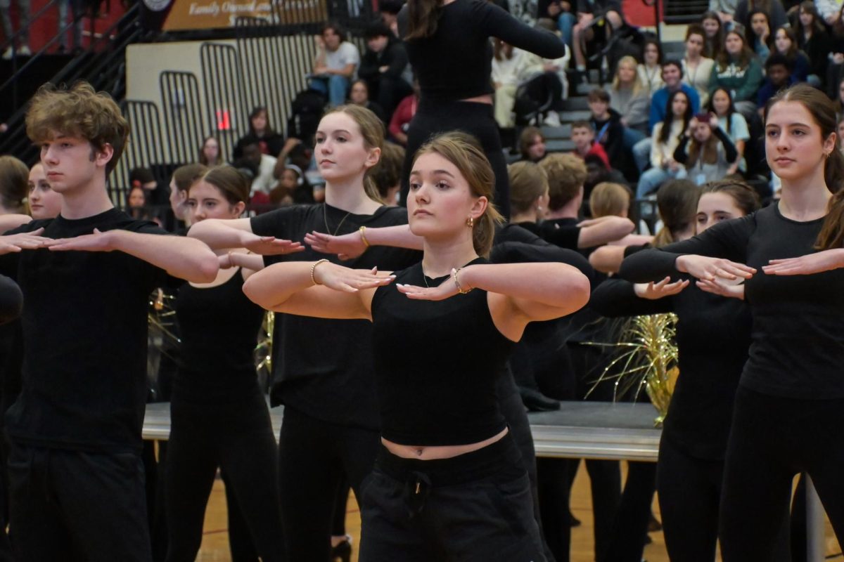 Junior Charlotte Rhoads and other "Chicago" cast members perform at the winter pep rally.