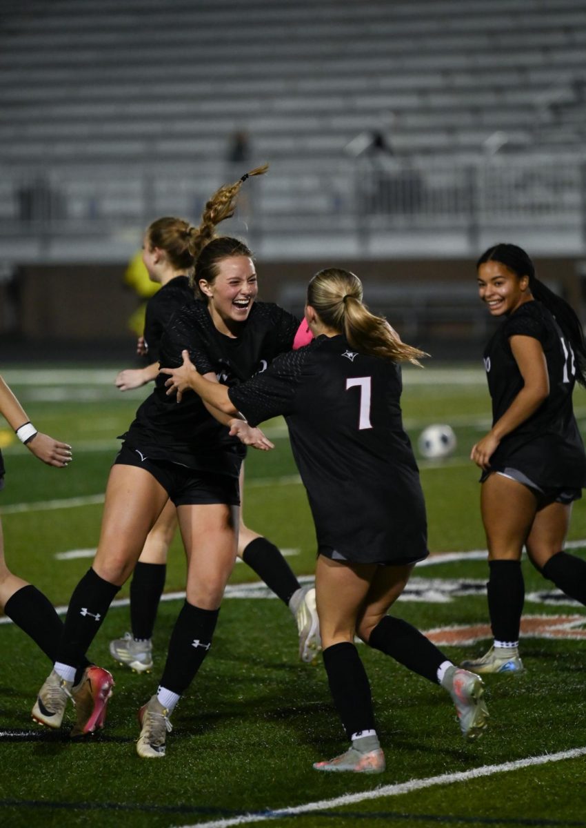Senior Natalie Gullo celebrates a good play with junior Avery Setters.